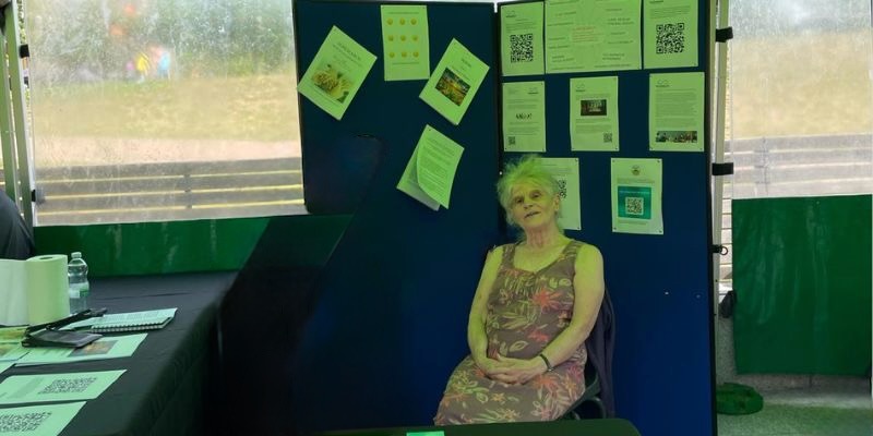 Photo of Barbara siting by Suresearch stall at event